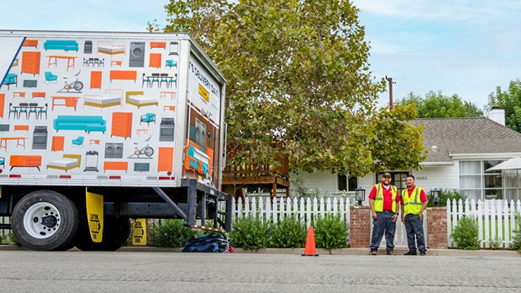 final mile truck with employees in front of a house